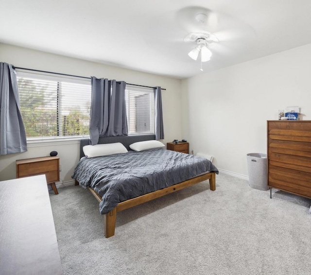 bedroom with ceiling fan, carpet, and baseboards