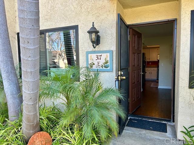 view of exterior entry featuring stucco siding