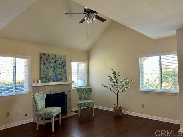 317 N Melrose Dr Unit E, Vista, CA 92083 - living area with plenty of natural light, wood finished floors, ceiling fan, baseboards, and high vaulted ceiling