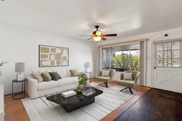 living room featuring hardwood / wood-style floors and ceiling fan