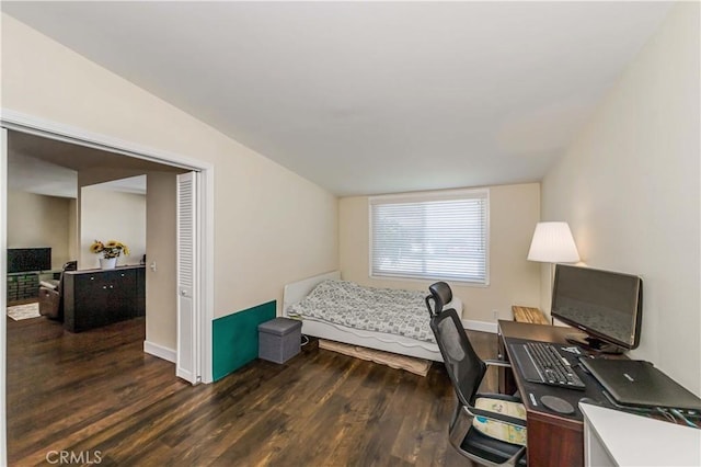 bedroom featuring lofted ceiling and dark wood-type flooring