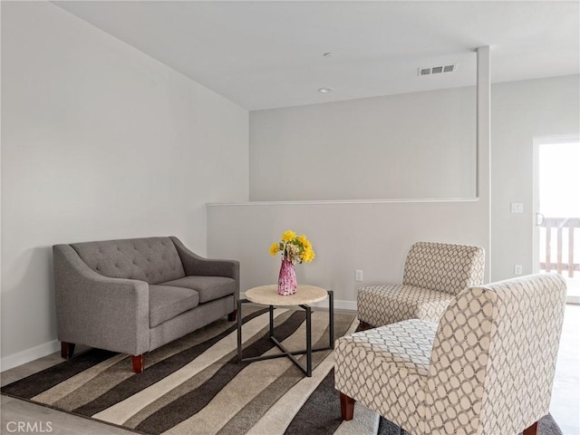 sitting room featuring visible vents and baseboards