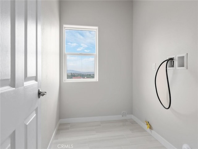 washroom featuring laundry area, hookup for a washing machine, gas dryer hookup, and baseboards