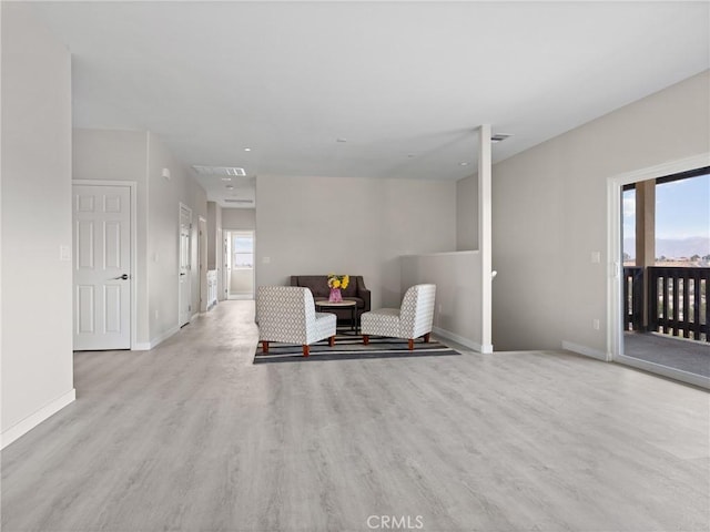 unfurnished room featuring visible vents, plenty of natural light, wood finished floors, and baseboards