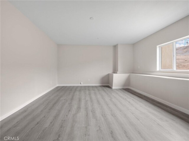 8411 Buckthorn Ave, Hesperia, CA 92345 - unfurnished room with wood finished floors and baseboards