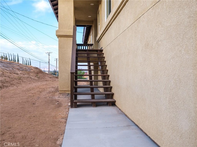 property entrance with stucco siding