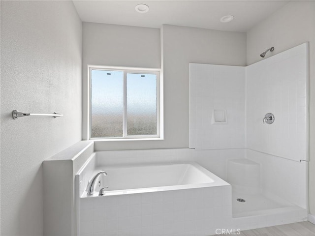 bathroom with a bath and walk in shower