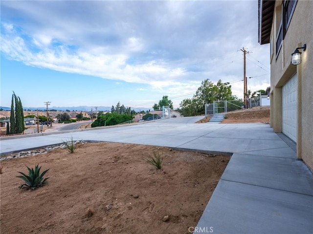 view of yard with concrete driveway