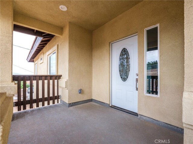 8411 Buckthorn Ave, Hesperia, CA 92345 - view of exterior entry featuring stucco siding and a balcony
