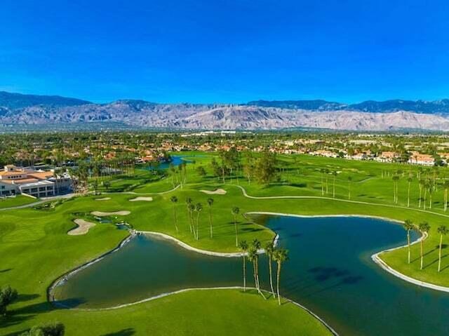 birds eye view of property with a water and mountain view