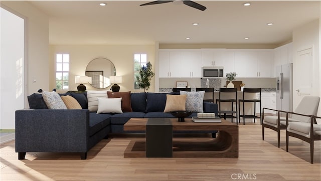 living room featuring ceiling fan and light wood-type flooring