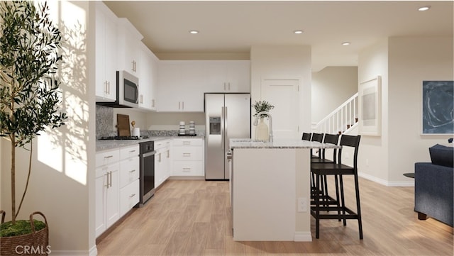 kitchen featuring white cabinetry, a center island, and appliances with stainless steel finishes