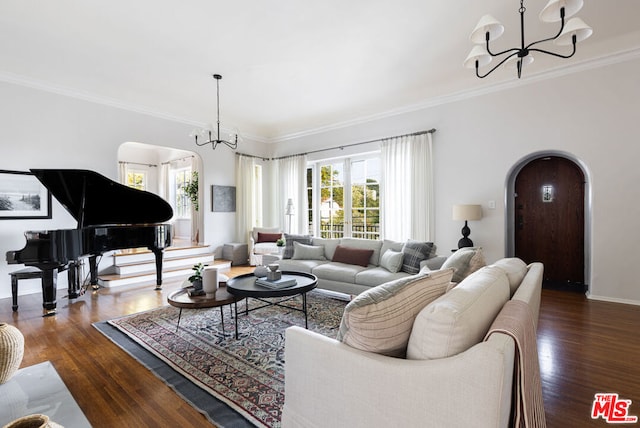 living room with ornamental molding, dark hardwood / wood-style floors, and an inviting chandelier