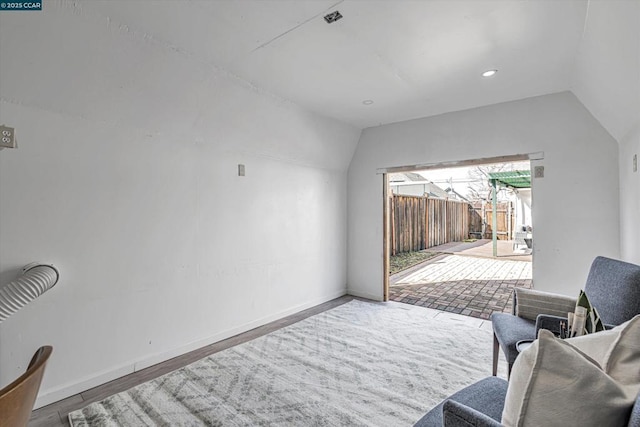 sitting room featuring vaulted ceiling and hardwood / wood-style floors