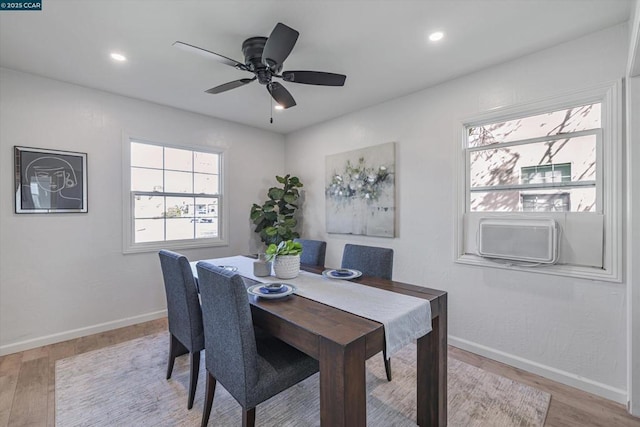 dining space with ceiling fan and light wood-type flooring