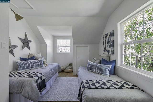 bedroom with hardwood / wood-style floors and vaulted ceiling