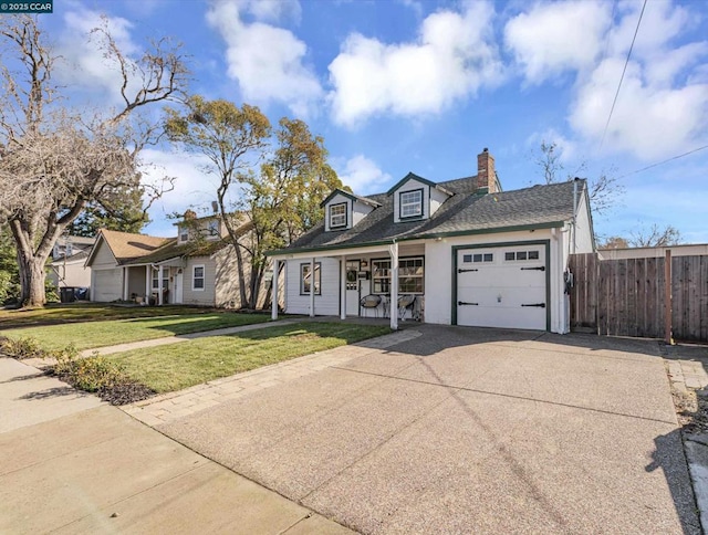 view of front of house with a garage, a front yard, and a porch