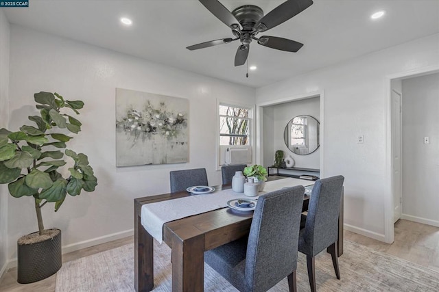 dining area featuring cooling unit, ceiling fan, and light wood-type flooring