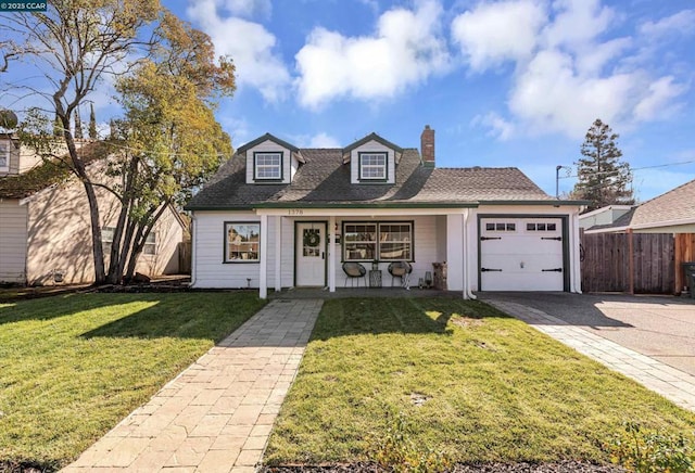 view of front of home featuring a porch, a garage, and a front yard