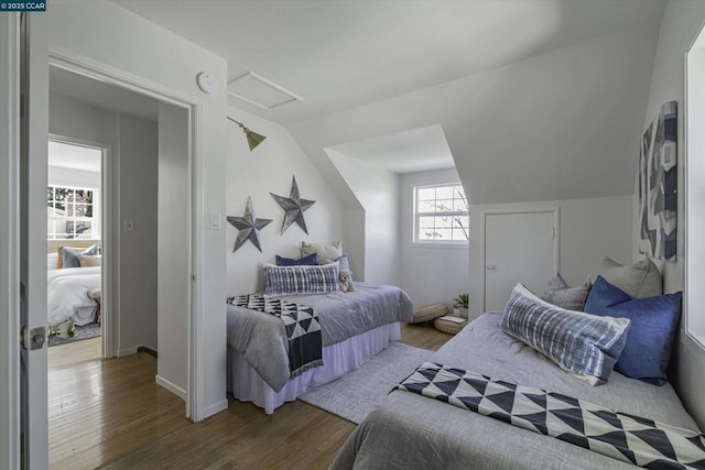 bedroom with hardwood / wood-style flooring and vaulted ceiling