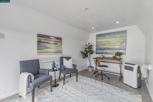 home office featuring hardwood / wood-style flooring and lofted ceiling