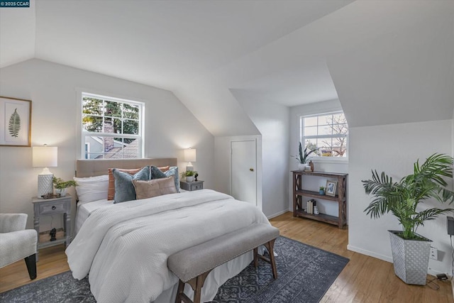 bedroom with light hardwood / wood-style flooring and vaulted ceiling