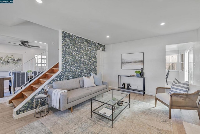 living room featuring ceiling fan and light hardwood / wood-style flooring