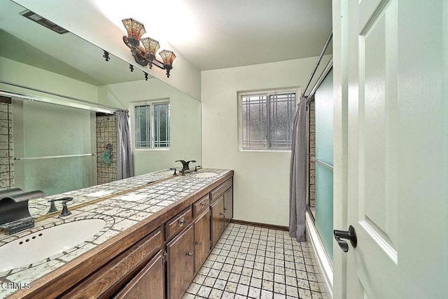 bathroom with vanity, tile patterned flooring, and shower / bath combo with shower curtain