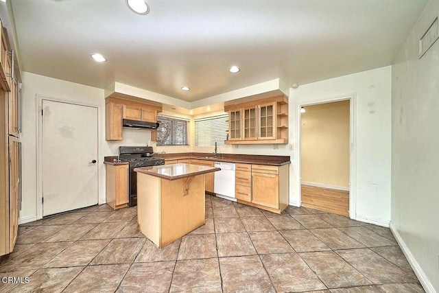 kitchen featuring sink, a center island, black gas range oven, a kitchen breakfast bar, and white dishwasher