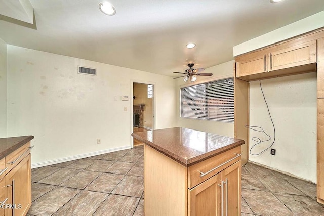 kitchen featuring a center island and ceiling fan