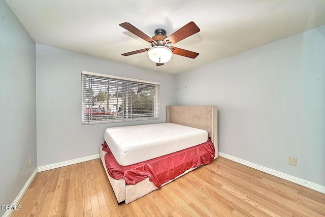 bedroom with ceiling fan and wood-type flooring