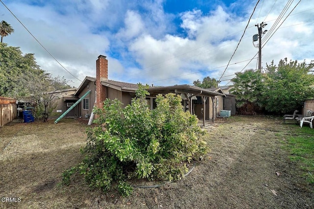 rear view of house featuring cooling unit