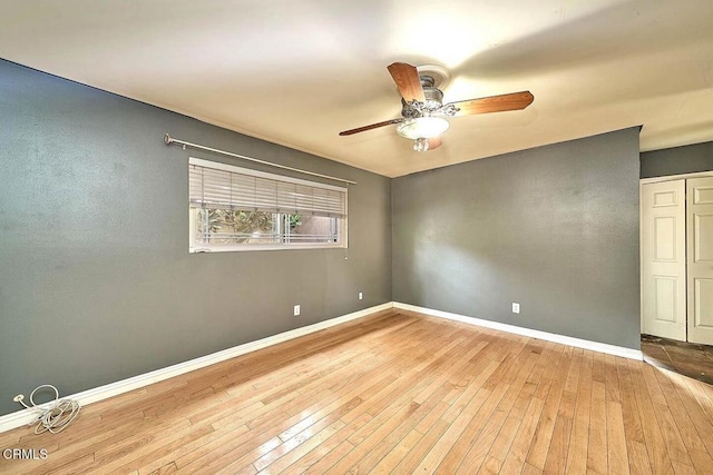 empty room with ceiling fan and light hardwood / wood-style floors