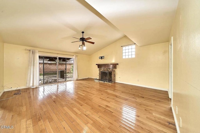 unfurnished living room featuring a stone fireplace, high vaulted ceiling, ceiling fan, and light wood-type flooring