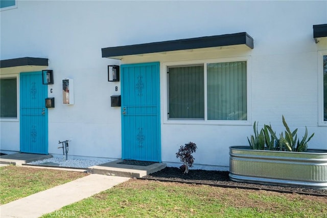 doorway to property featuring a yard