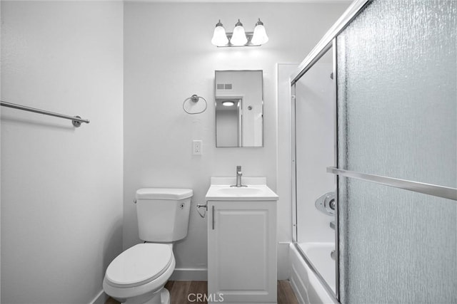 full bathroom featuring vanity, wood-type flooring, enclosed tub / shower combo, and toilet