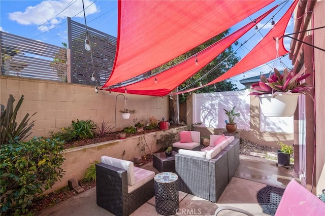 view of patio featuring an outdoor hangout area and a fenced backyard