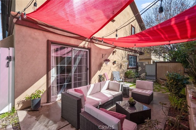 view of patio / terrace featuring outdoor lounge area and fence