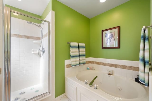 bathroom with a shower stall and a tub with jets