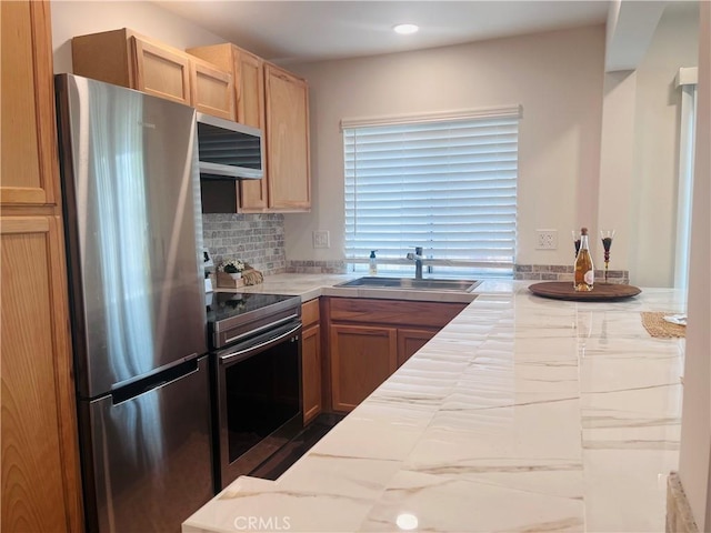 kitchen featuring tasteful backsplash, appliances with stainless steel finishes, and sink