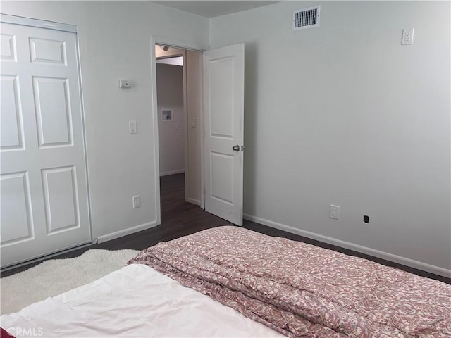 bedroom featuring dark hardwood / wood-style flooring