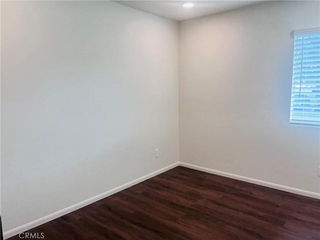 spare room featuring dark wood-type flooring