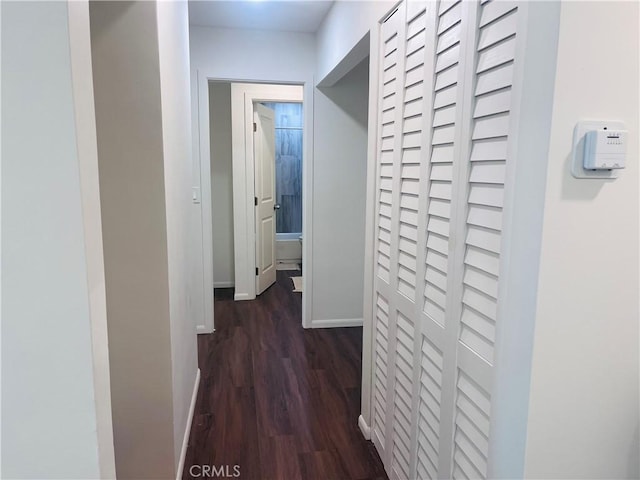 corridor with dark hardwood / wood-style flooring