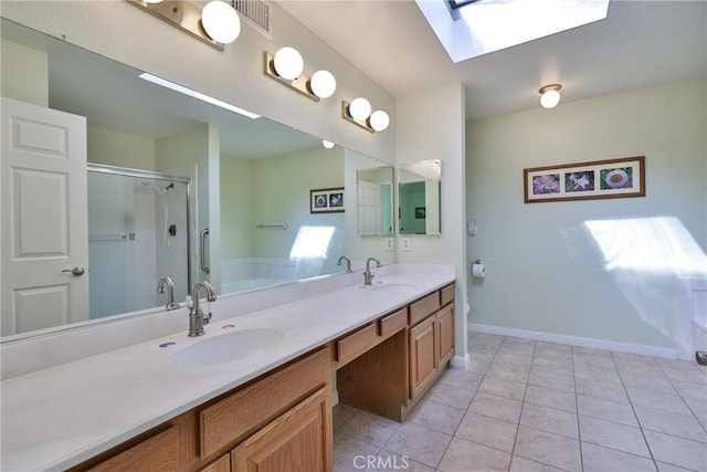 bathroom featuring vanity, tile patterned flooring, a skylight, and separate shower and tub