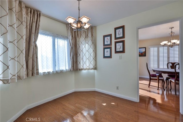 interior space featuring hardwood / wood-style floors and a notable chandelier