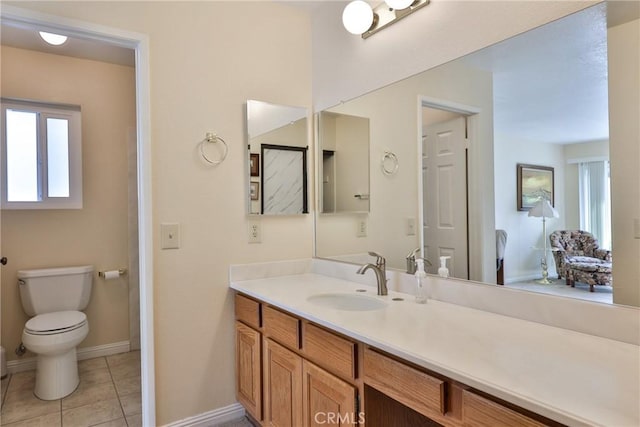 bathroom featuring vanity, tile patterned flooring, and toilet