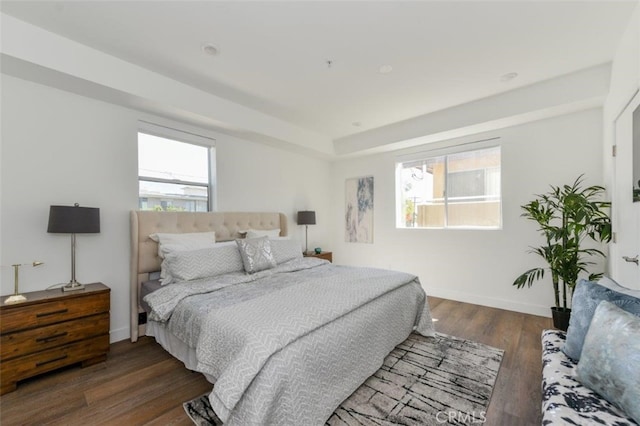 bedroom with dark hardwood / wood-style floors