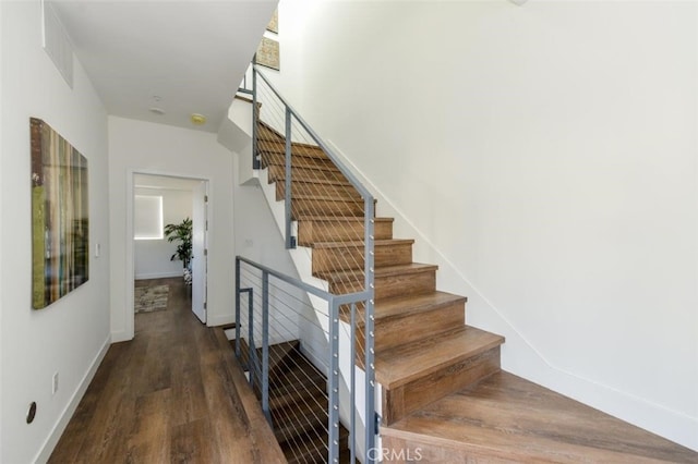 staircase featuring hardwood / wood-style floors