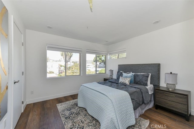 bedroom with dark hardwood / wood-style flooring