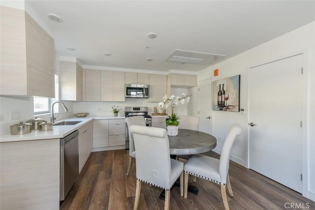 dining area featuring sink and dark hardwood / wood-style floors